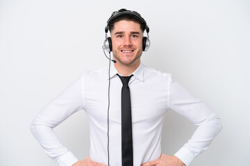 Telemarketer caucasian man isolated on white background posing with arms at hip and smiling
