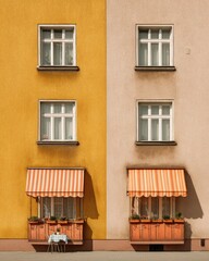 Two-toned building facade with awning and balcony