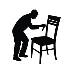 Fototapeta premium Silhouette of a man repairing or painting a chair with a brush