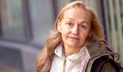 A portrait of a lady, a 60+ age charming woman with a smiley face.