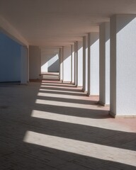 Obraz premium Sunlit colonnade, long shadows stretching through a hallway