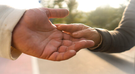 Hands closeup, man and woman support each other.