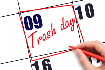 9th day of the month.  Hand writing Trash day reminder and drawing red frame on calendar with red...