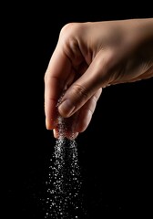 Hand sprinkling salt seasoning food