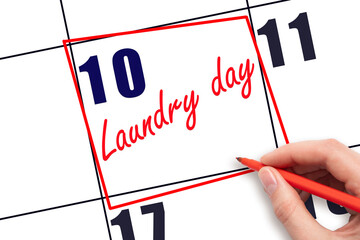 10th day of the month.  Hand writing Laundry day reminder and drawing red frame on calendar with...