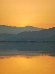 Shy Sunrise Behind the Hills at Dawn