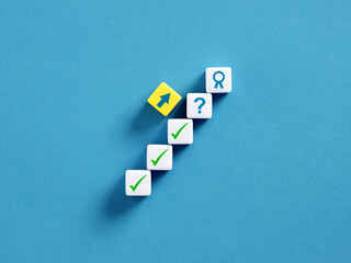 Building success steps to achieve your goals with checkmark cubes