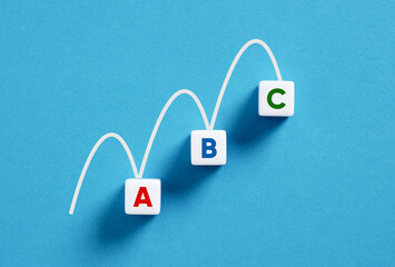 White line is connecting three cubes forming increasing chart on blue background