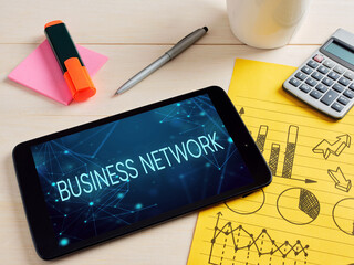 Business network concept showing on digital tablet surrounded by office supplies