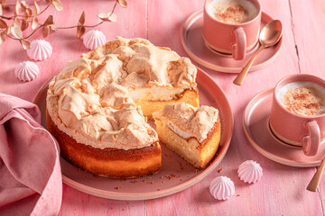 Delicious meringue cheesecake served on red porcelain.