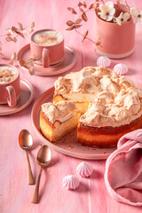 Tasty meringue cheesecake served on red porcelain.