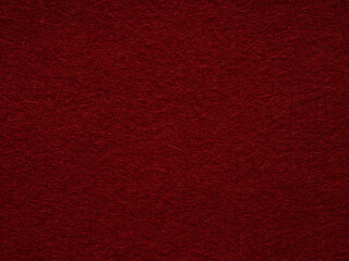 A textural symphony in crimson, the intimate landscape of a red felt surface invites tactile contemplation