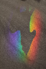 Rainbow is reflected in a black surface