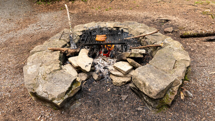 A barbeucue with saussages in mountains in Switzerland on july 20th 2025