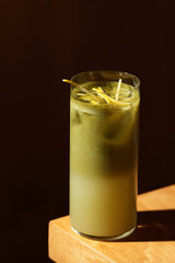 Layered Green Cocktail with Lemon Zest Garnish