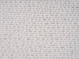 Textured light gray veneer surface with an embossed grid pattern