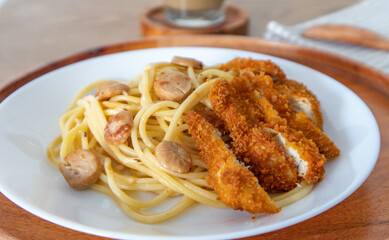 Chicken cutlet or katsu served over spaghetti, pasta