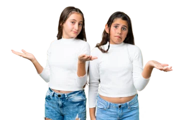 Fotobehang Friends girls holding gift and a birthday cake over isolated chroma key background unhappy and frustrated with something because not understand something © luismolinero