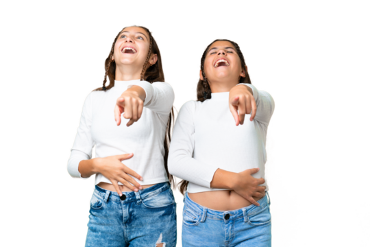 Friends girls holding gift and a birthday cake over isolated chroma key background pointing with finger at someone and laughing a lot - Powered by Adobe