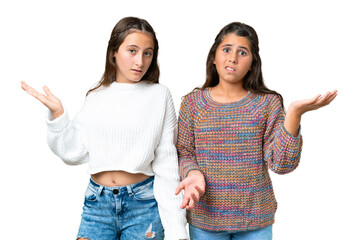 Friends girls over isolated chroma key background having doubts and with confuse face expression