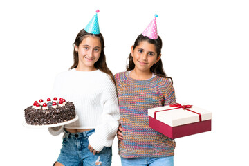 Friends girls holding gift and a birthday cake over isolated chroma key background posing with arms...