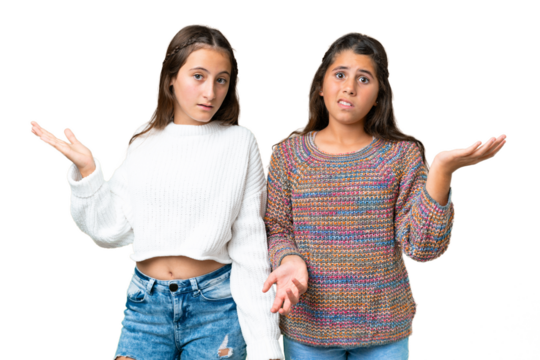 Friends girls over isolated chroma key background having doubts and with confuse face expression