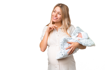 Young pretty pregnant woman with her newborn baby over isolated chroma key background thinking an idea and looking side