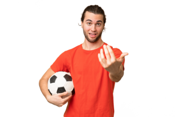 Young handsome man isolated on green chroma background with soccer ball and doing coming gesture