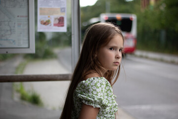 Pensive Girl Waiting at Bus Stop