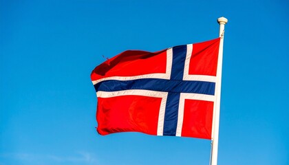Norway flag against crisp blue sky, bold red field with Nordic cross in blue and white, hoist-shifted classic layout, national pride and minimalist heritage focus.