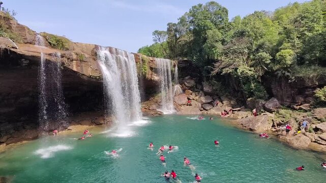 Krang Shuri water falls of Meghalaya with people are swimming.