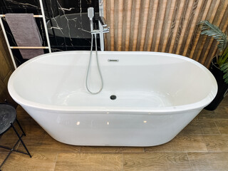 A beautifully designed bathroom boasts a stylish and sleek white bathtub alongside a modern shower...