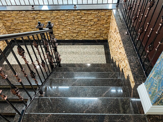 A beautifully designed staircase featuring an elegant wrought iron railing complemented by a sturdy...