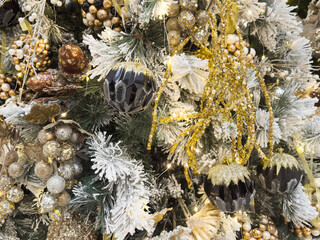 Beautiful festive decorations on the Christmas tree. Close-up. Beautiful Christmas background. The concept of decorations and decor for the new year. New Year's Card 2025