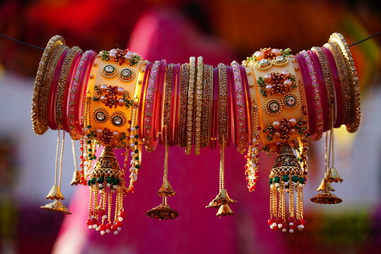 Traditional Indian bridal chooda (wedding bangles) adorned with kalire, displayed against a clear blue sky, symbolizing cultural heritage and matrimonial celebration