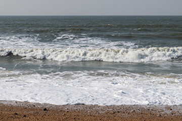 tranquil seascape with breaking waves on the beach in winter