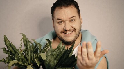 A man takes care of house plants.