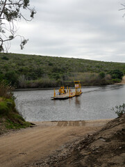 pontoon transporting vehicles over the Breede River between Witsand and Malgas.  Location Western Cape South Africa. vertical image
