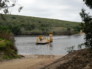 pontoon transporting vehicles over the Breede River between Witsand and Malgas.  Location Western Cape South Africa. vertical image