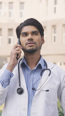 Vertical Photo of Indian Doctor Talking on Phone Call