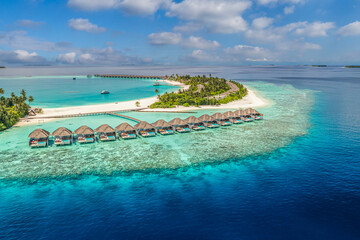 Tranquil aerial view Maldives tropical island water villas turquoise lagoon bay horizon blue sky sunny exotic coast ocean luxury travel summer holiday vacation destination scenic beach wallpaper
