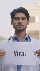 Vertical Photo of Indian Doctor Holding Viral Poster