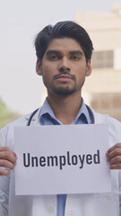 Vertical Photo of Indian Doctor Holding Unemployed Poster