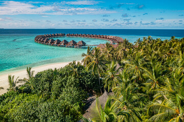 Tranquil aerial view Maldives tropical island water villas turquoise lagoon bay horizon blue sky sunny exotic coast ocean luxury travel summer holiday vacation destination scenic beach wallpaper
