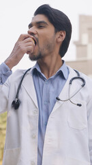 Vertical Photo of Indian Doctor Eating Apple