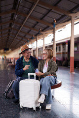 Older Asian Couple Enjoying Travel Sitting Train Station Happy Retirement Vacation Journey Waiting...