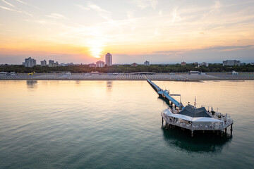 Lignano Pineta beach in Italy. Eempty sunbeds and calm sea during summer vacation.