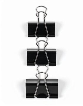 A creative arrangement of black binder clips stacked vertically for an appealing office or organizational concept.