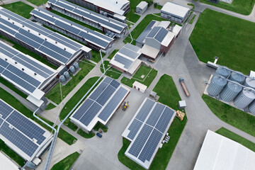 Modern poultry farm with solar panels. Factory using renewable energy. Aerial view