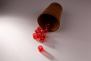 A random arrangement of dice and a puzzle cup, captured after the dice have been cast.